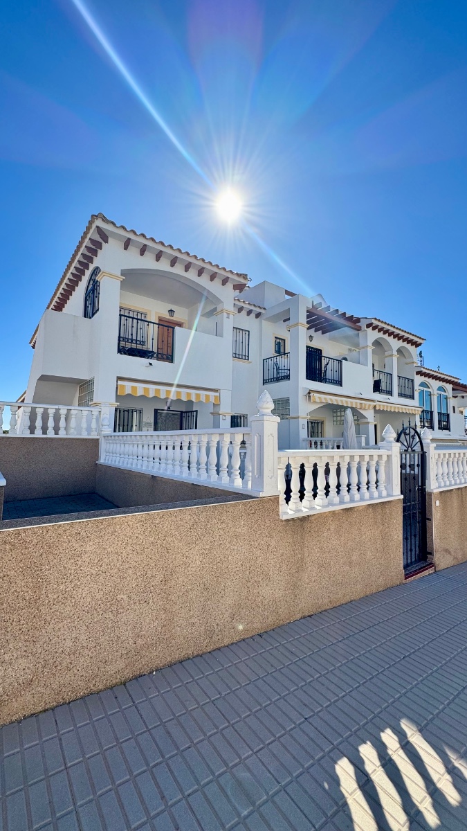 Located in a pleasant residential complex with a communal pool, this charming single-story bungalow