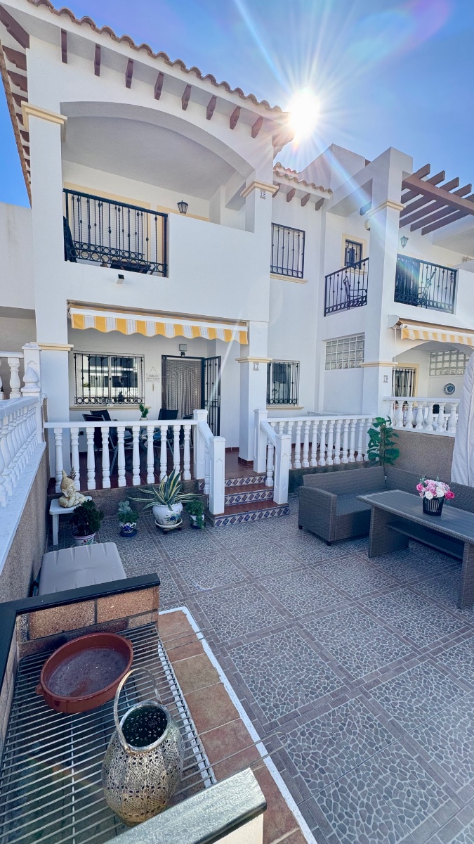 Located in a pleasant residential complex with a communal pool, this charming single-story bungalow