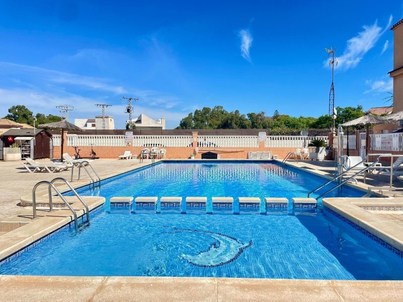This charming two-bedroom penthouse, located on the first floor of a building without a lift, offers