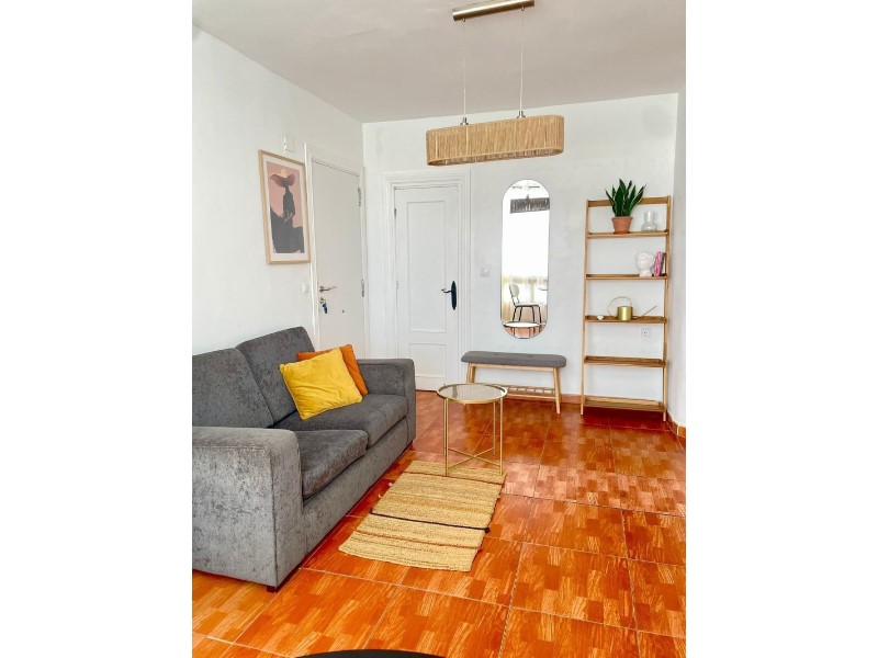 This charming two-bedroom penthouse, located on the first floor of a building without a lift, offers