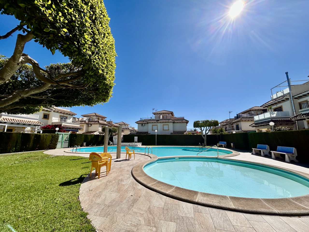 This beautifully presented top-floor apartment in sought-after Punta Prima offers the perfect combin
