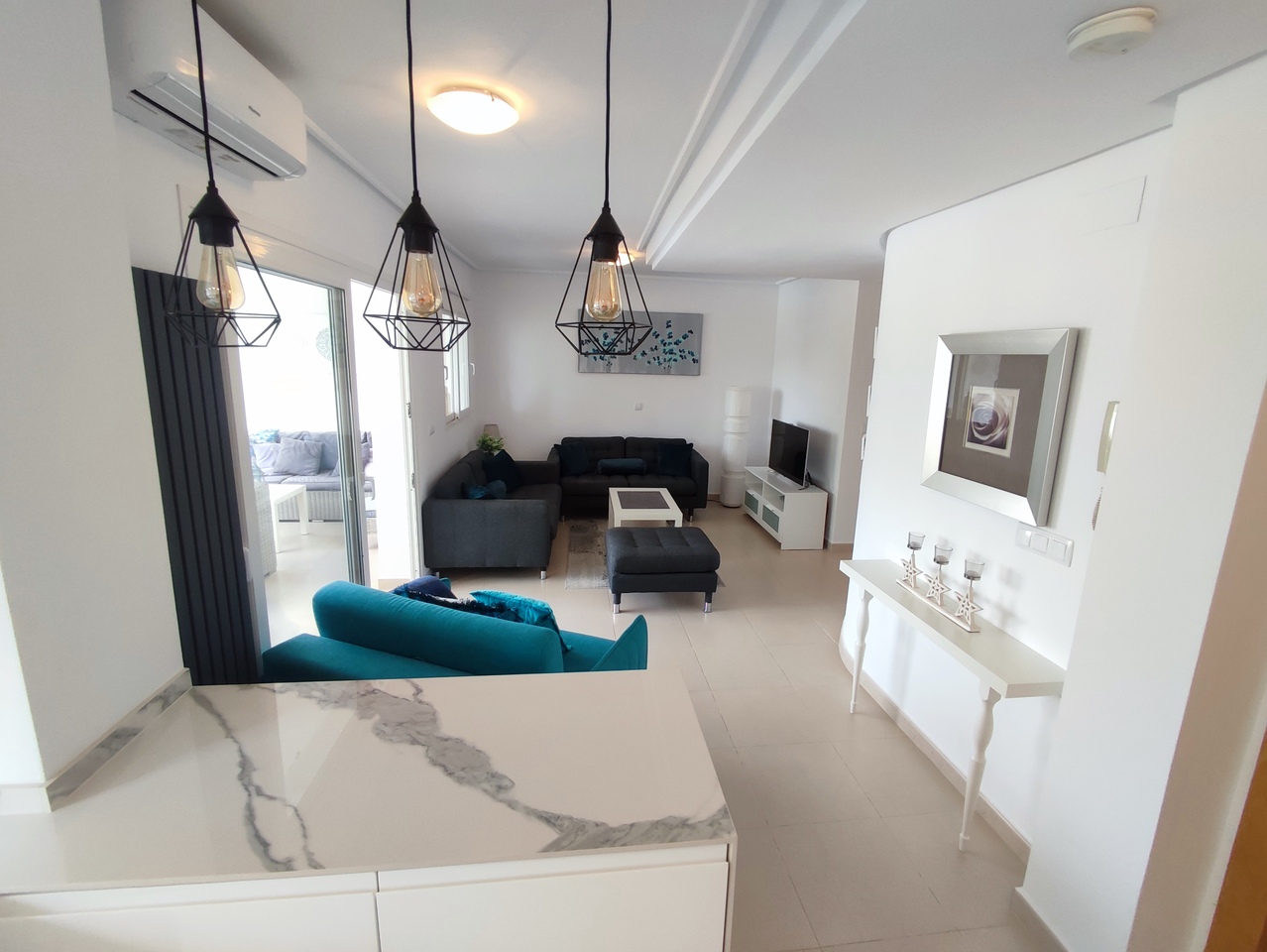 This popular curved wall design apartment has an attractive view of the swimming pool from its spacious terrace with pleanty of room for garden furniture and table & chairs